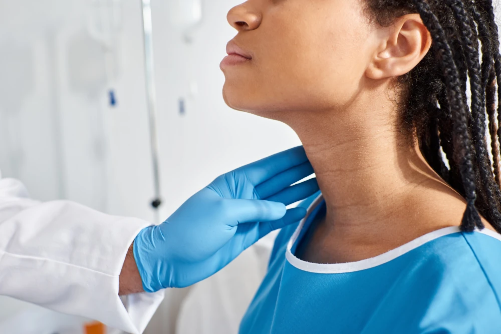 Provider assessing thyroid — personalized autoimmune and thyroid care